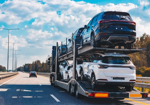 Car transport truck driving on highway road. Car Carrier Trailer on asphalt road